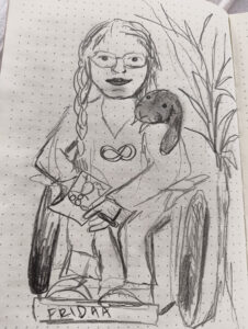 Pencil drawing of a woman smiling and sitting in a wheelchair. There is an infinity symbol on her shirt, and a round little animal is peeking over her shoulder.